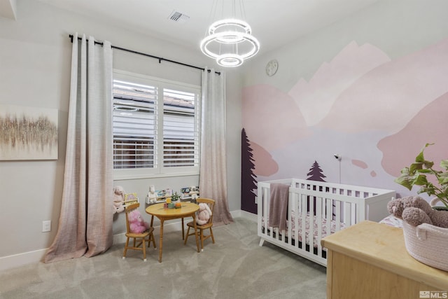 bedroom featuring carpet floors, a chandelier, a nursery area, and baseboards