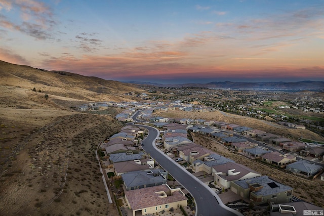 aerial view at dusk of a residential view and a mountain view