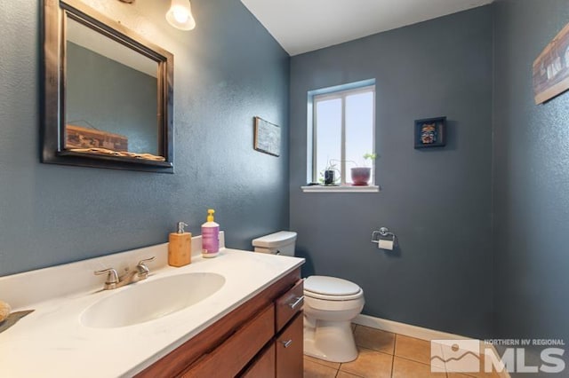 3920 W 7th St, Reno, NV 89503 - bathroom with toilet, tile patterned flooring, vanity, and baseboards