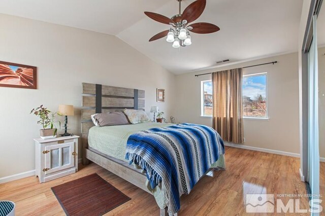 3920 W 7th St, Reno, NV 89503 - bedroom with light wood-type flooring, vaulted ceiling, baseboards, and a ceiling fan