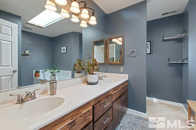 3920 W 7th St, Reno, NV 89503 - bathroom featuring tile patterned floors, double vanity, baseboards, and a chandelier