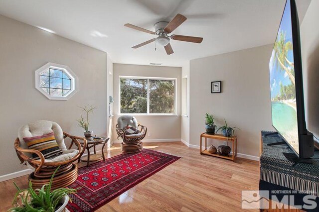 3920 W 7th St, Reno, NV 89503 - sitting room with light wood-style floors, a ceiling fan, and baseboards