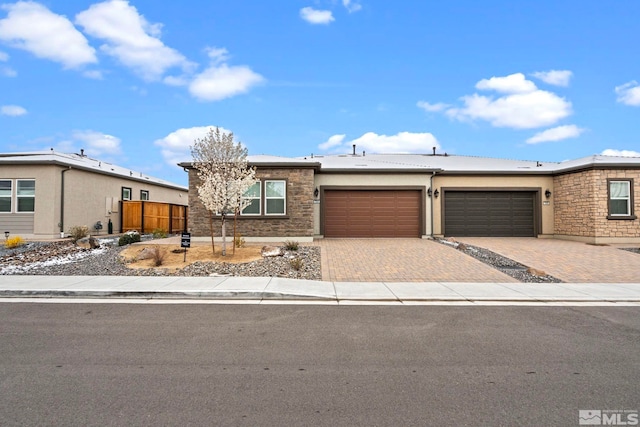 7393 Oakmont Ln, Sparks, NV 89441 - view of front of property with an attached garage, decorative driveway, stucco siding, and stone siding