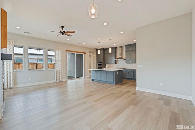 7393 Oakmont Ln, Sparks, NV 89441 - kitchen with wall chimney range hood, open floor plan, light countertops, and recessed lighting