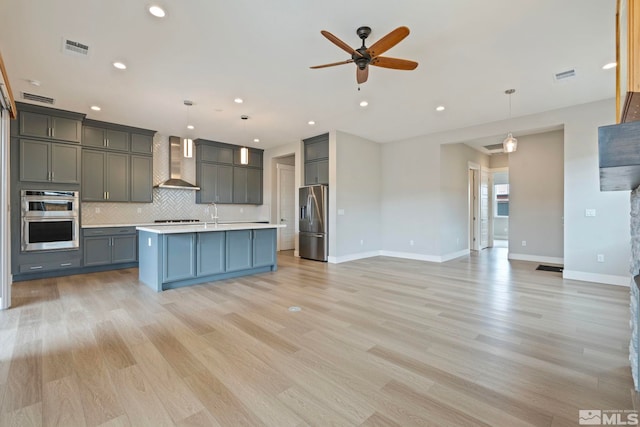 7393 Oakmont Ln, Sparks, NV 89441 - kitchen featuring appliances with stainless steel finishes, wall chimney exhaust hood, light countertops, tasteful backsplash, and a ceiling fan