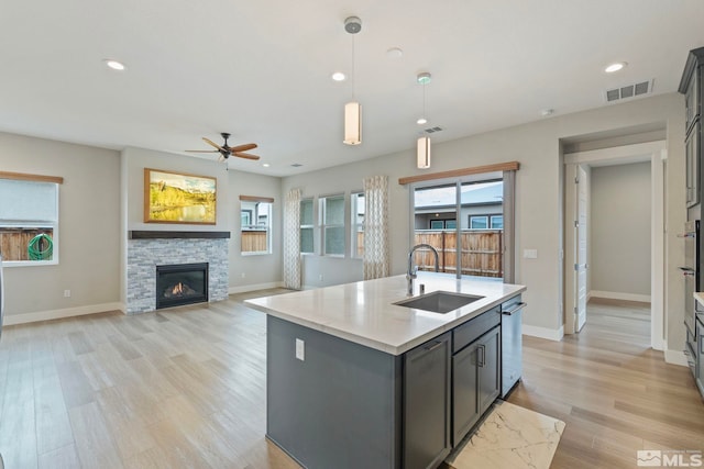 7393 Oakmont Ln, Sparks, NV 89441 - kitchen with a sink, light countertops, a ceiling fan, a fireplace, and baseboards