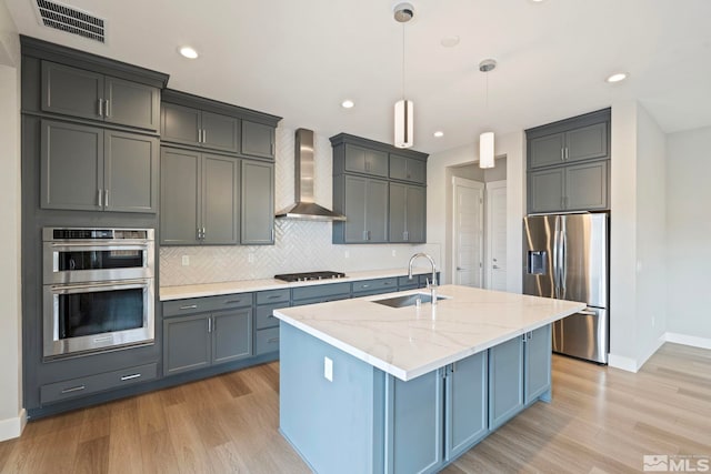 7393 Oakmont Ln, Sparks, NV 89441 - kitchen with stainless steel appliances, wall chimney exhaust hood, a sink, baseboards, and tasteful backsplash