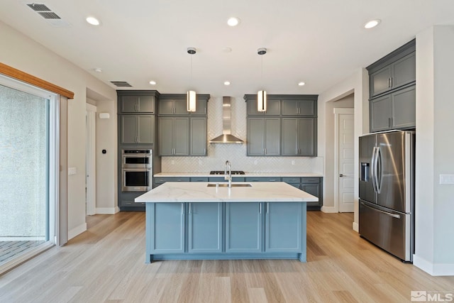 7393 Oakmont Ln, Sparks, NV 89441 - kitchen with stainless steel appliances, wall chimney exhaust hood, light wood-style flooring, backsplash, and recessed lighting