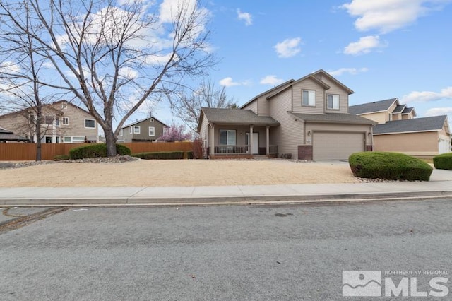 7655 Los Lagos Ave, Sparks, NV 89436 - view of front of house with a garage, fence, covered porch, and driveway