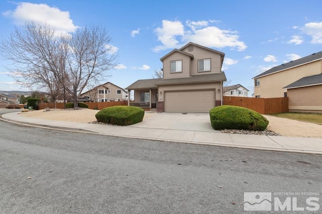 7655 Los Lagos Ave, Sparks, NV 89436 - traditional-style house with fence, an attached garage, driveway, and brick siding