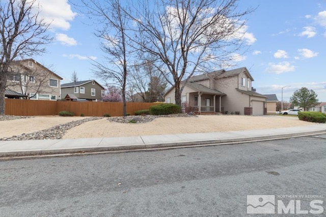7655 Los Lagos Ave, Sparks, NV 89436 - view of front facade with fence, a residential view, a garage, and driveway