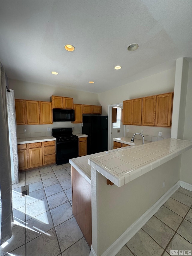 7655 Los Lagos Ave, Sparks, NV 89436 - kitchen featuring black appliances, a peninsula, brown cabinets, recessed lighting, and baseboards