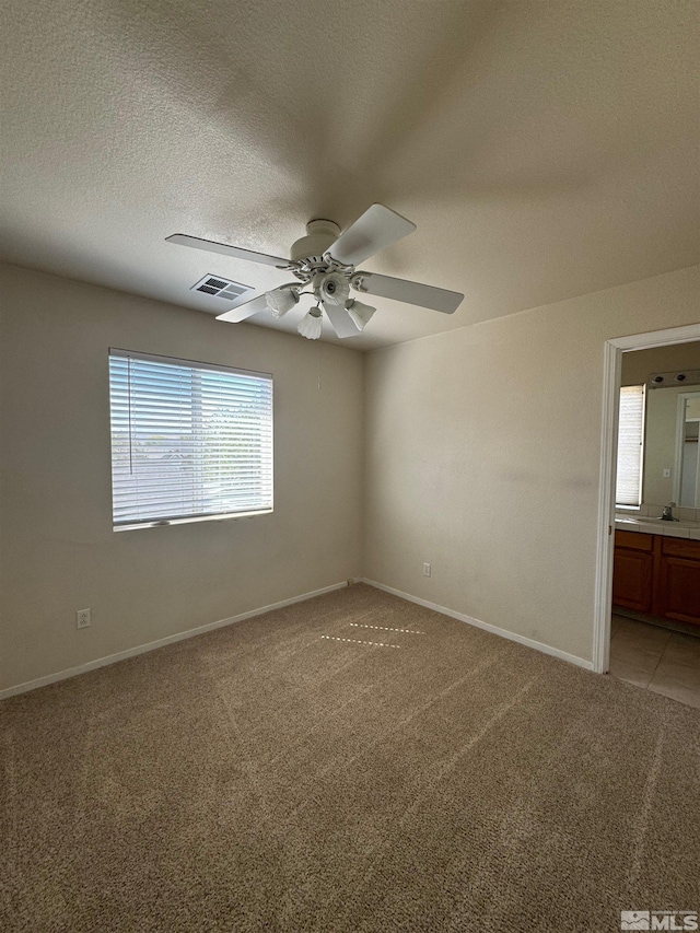 7655 Los Lagos Ave, Sparks, NV 89436 - empty room featuring light colored carpet, a ceiling fan, baseboards, and a textured ceiling