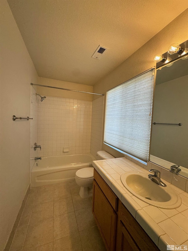 7655 Los Lagos Ave, Sparks, NV 89436 - full bath with toilet, tile patterned floors, a textured ceiling, vanity, and shower / bathtub combination