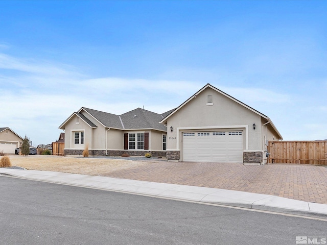 11641 Vista Park Dr, Sparks, NV 89441 - ranch-style house with stone siding, stucco siding, a garage, decorative driveway, and fence