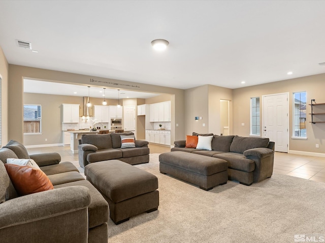 11641 Vista Park Dr, Sparks, NV 89441 - living room with light tile patterned floors, baseboards, recessed lighting, plenty of natural light, and light colored carpet