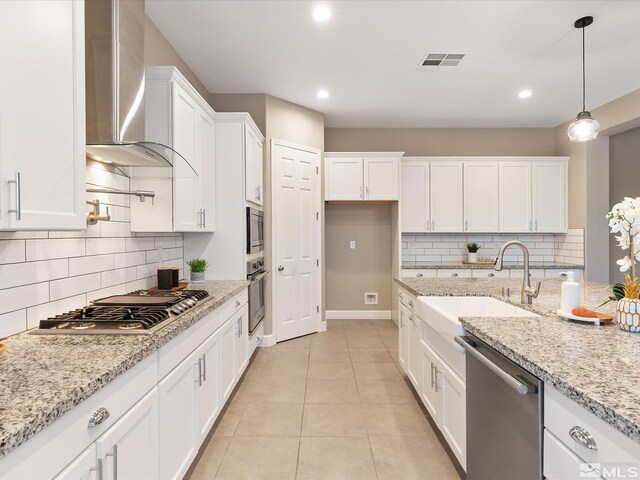 11641 Vista Park Dr, Sparks, NV 89441 - kitchen with appliances with stainless steel finishes, wall chimney range hood, a sink, white cabinetry, and backsplash