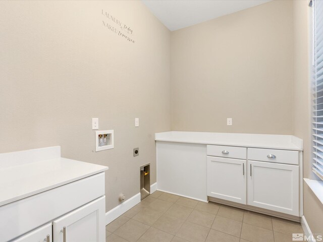 11641 Vista Park Dr, Sparks, NV 89441 - laundry room with electric dryer hookup, washer hookup, cabinet space, light tile patterned floors, and baseboards