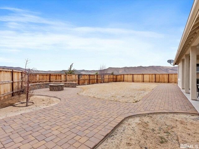 11641 Vista Park Dr, Sparks, NV 89441 - view of patio featuring a fire pit and a fenced backyard