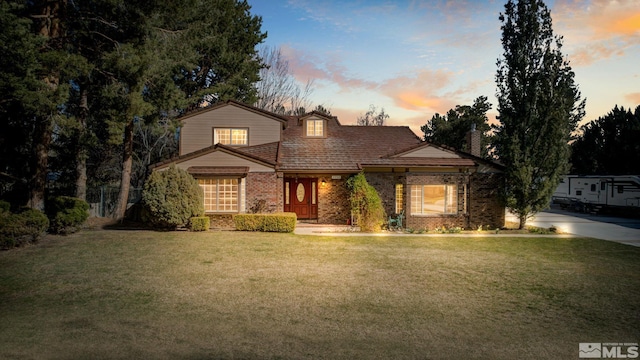 2266 W Washington St, Carson City, NV 89703 - traditional-style home with a front lawn, brick siding, and a chimney