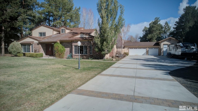 2266 W Washington St, Carson City, NV 89703 - view of front of house featuring driveway, a front lawn, brick siding, and an attached garage