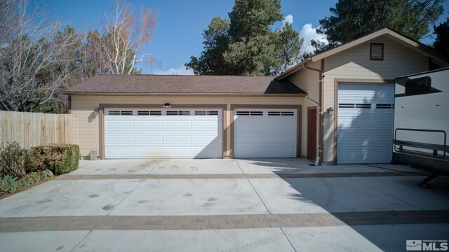 2266 W Washington St, Carson City, NV 89703 - garage featuring concrete driveway and fence