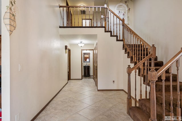 2266 W Washington St, Carson City, NV 89703 - stairway with a high ceiling, baseboards, and tile patterned flooring