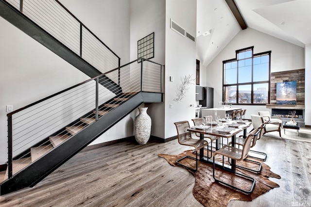 28 Beach Club Dr Unit 408, Stateline, NV 89449 - dining space featuring high vaulted ceiling, stairs, hardwood / wood-style floors, beamed ceiling, and baseboards