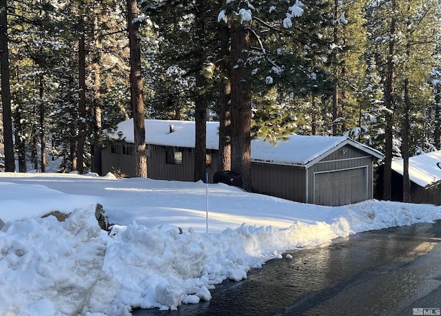 255 Sherwood Ct, Stateline, NV 89449 - view of snowy exterior with a garage