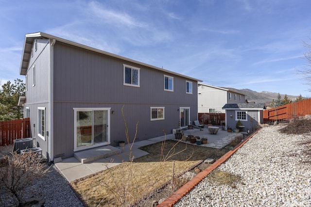 18190 Cody Ct, Reno, NV 89508 - rear view of property with a patio area, a fenced backyard, an outdoor structure, central air condition unit, and a shed