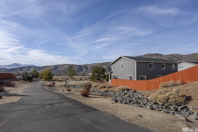 18190 Cody Ct, Reno, NV 89508 - view of side of home featuring a mountain view and fence