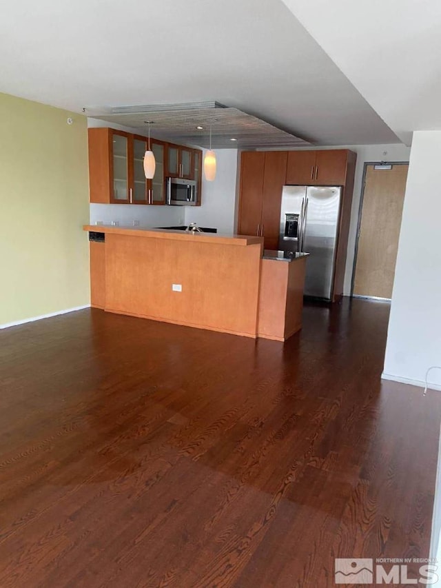 255 N Sierra St Unit 1709, Reno, NV 89501 - kitchen featuring appliances with stainless steel finishes, a peninsula, glass insert cabinets, dark wood finished floors, and brown cabinets