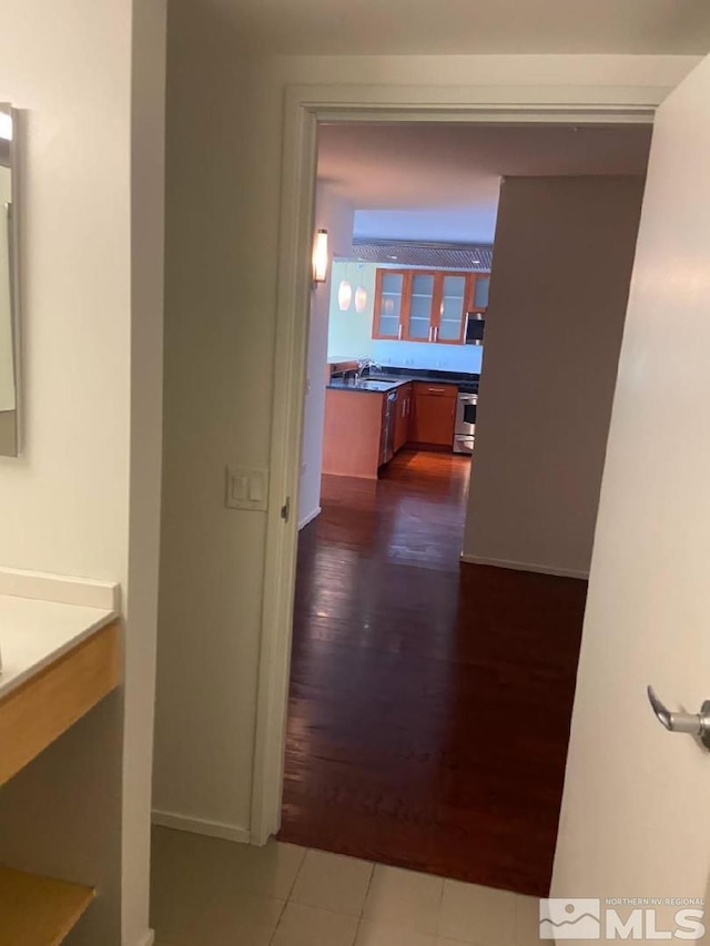 255 N Sierra St Unit 1709, Reno, NV 89501 - corridor with dark wood-style floors, baseboards, and a sink