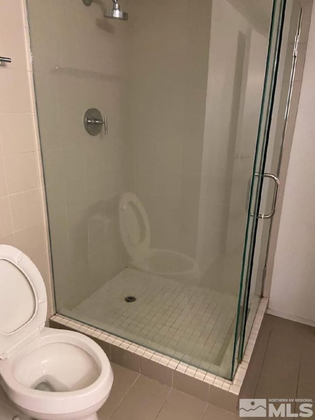 255 N Sierra St Unit 1709, Reno, NV 89501 - full bath with tile patterned floors, a shower stall, and toilet