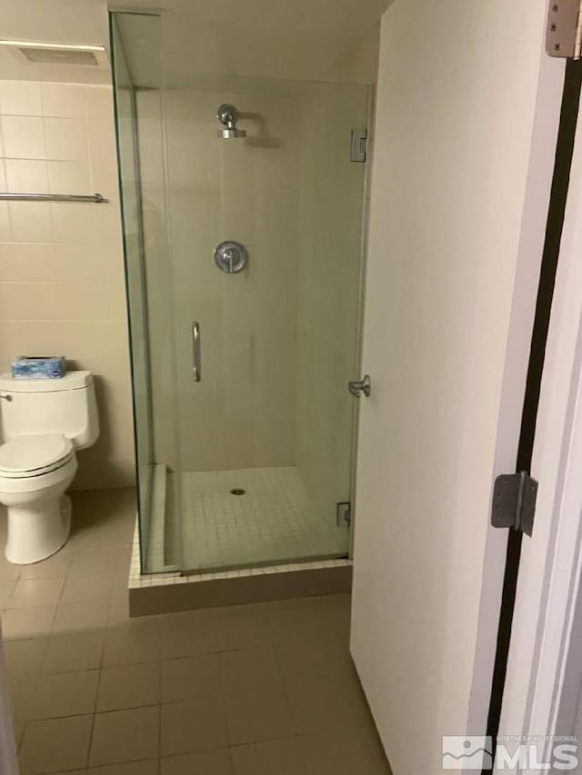 255 N Sierra St Unit 1709, Reno, NV 89501 - full bath featuring tile patterned flooring, a stall shower, and toilet