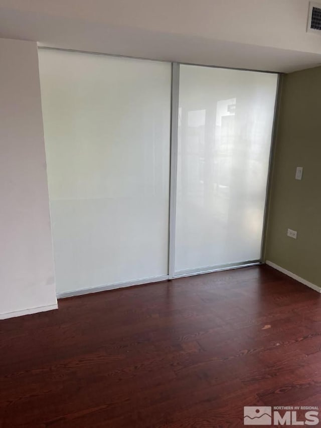 255 N Sierra St Unit 1709, Reno, NV 89501 - empty room featuring dark wood-style flooring and baseboards