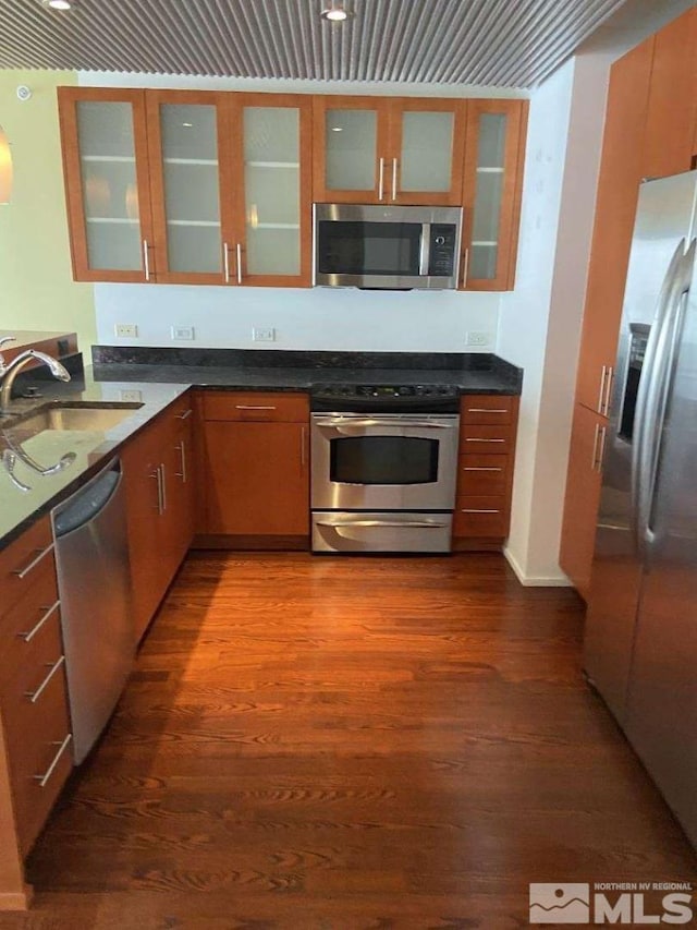 255 N Sierra St Unit 1709, Reno, NV 89501 - kitchen with appliances with stainless steel finishes, dark wood-style floors, dark countertops, and a sink