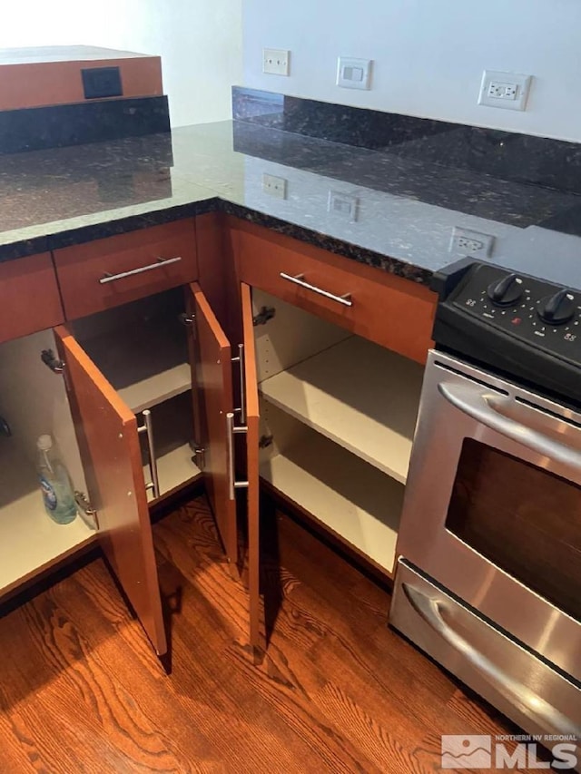 255 N Sierra St Unit 1709, Reno, NV 89501 - kitchen view of stainless steel electric stove, dark wood-type flooring, and dark stone countertops