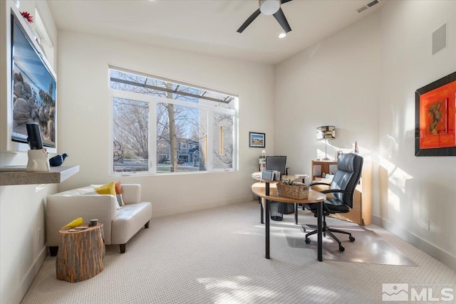 home office featuring vaulted ceiling, a ceiling fan, carpet, and baseboards
