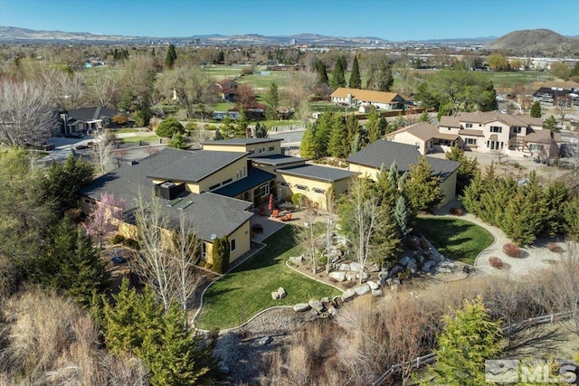 view of property location featuring mountains and nearby suburban area