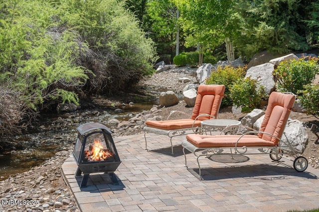 view of patio / terrace with an outdoor fire pit