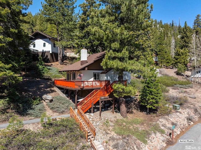 1348 Tirol Dr, Incline Village, NV 89451 - rear view of house featuring stairs, a deck, and a chimney