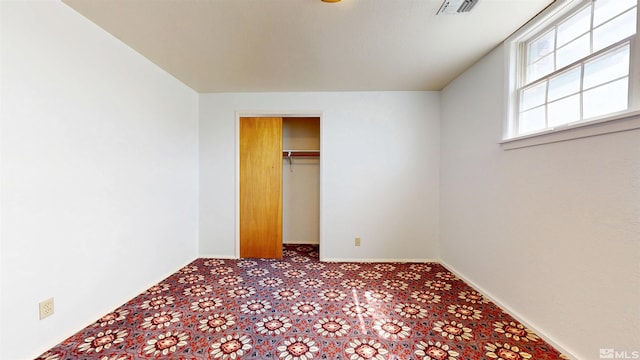 unfurnished bedroom featuring carpet flooring and baseboards