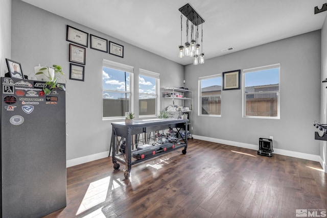 696 Raptor Way, Fernley, NV 89408 - office space featuring hardwood / wood-style floors, a wood stove, and baseboards
