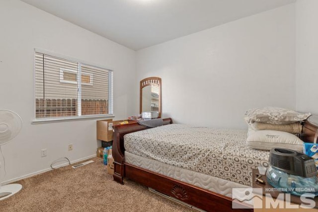 bedroom with carpet floors and baseboards