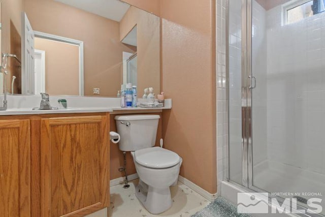 full bathroom featuring a shower stall, toilet, vanity, and baseboards
