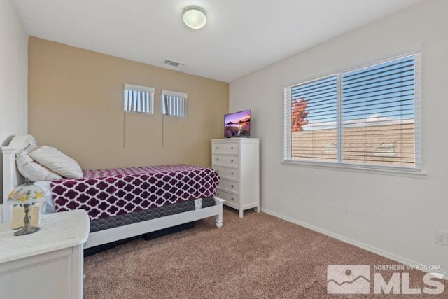 carpeted bedroom with baseboards