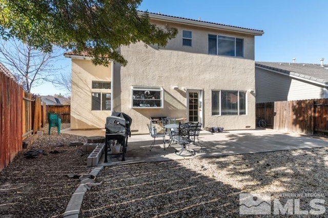 rear view of property with a patio, a fenced backyard, and stucco siding