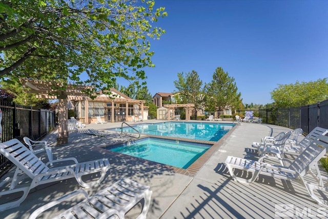 6140 Ingleston Dr Unit 525, Sparks, NV 89436 - community pool with fence, a hot tub, a patio area, and a pergola