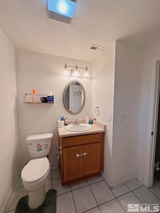 695 York Way, Sparks, NV 89431 - bathroom featuring tile patterned flooring, vanity, toilet, baseboards, and a textured ceiling